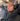 charcoal gray sloodie being worn on plane with headphones and hat on