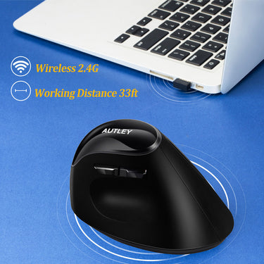 large ergonomic black travel mouse with laptop in background