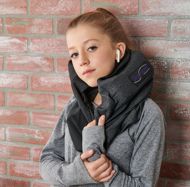 charcoal sleep hoodie worn by model in front of a brick background